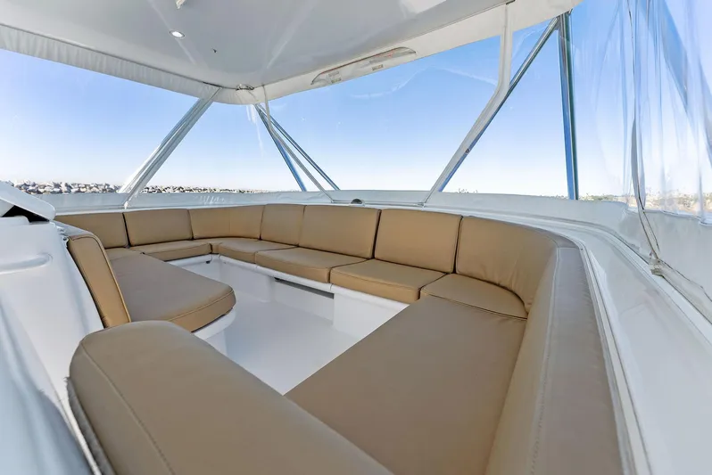 Chupacabra Yacht Photos Pics Spacious seating area on a 2007 Hatteras 64 Convertible yacht with panoramic windows.