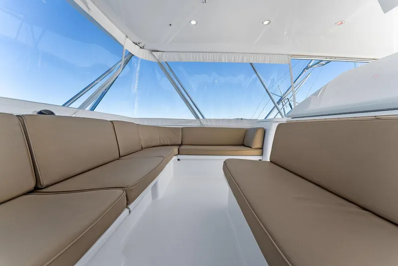 Chupacabra Yacht Photos Pics Interior seating area of 2007 Hatteras 64 Convertible yacht with panoramic windows.
