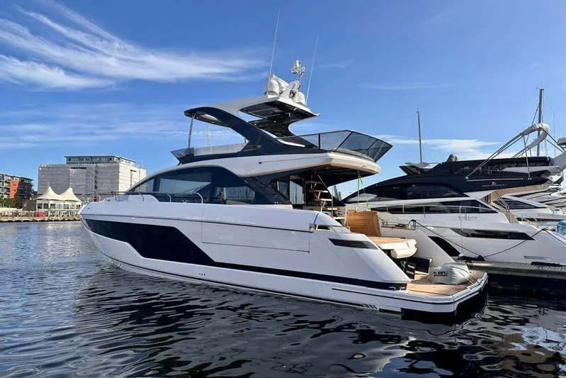 In Stock Yacht Photos Pics 2024 Fairline Squadron 58 luxury yacht docked in a marina under clear blue skies.