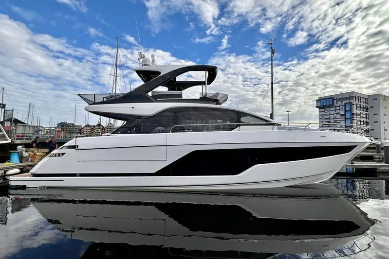 In Stock Yacht Photos Pics 2024 Fairline Squadron 58 yacht docked at marina under blue sky.