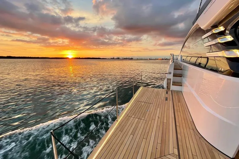 In Stock Yacht Photos Pics 2024 Fairline Squadron 58 yacht cruising at sunset, showcasing elegant deck design.