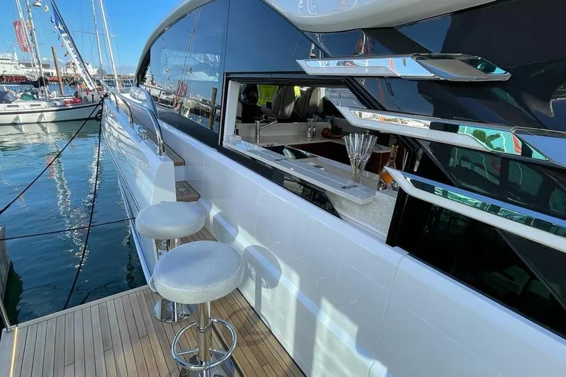 In Stock Yacht Photos Pics 2024 Fairline Squadron 58 yacht with sleek design and outdoor bar area.