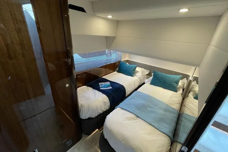 In Stock Yacht Photos Pics Luxurious twin cabin in 2024 Fairline Squadron 58 yacht, featuring modern design and cozy bedding.