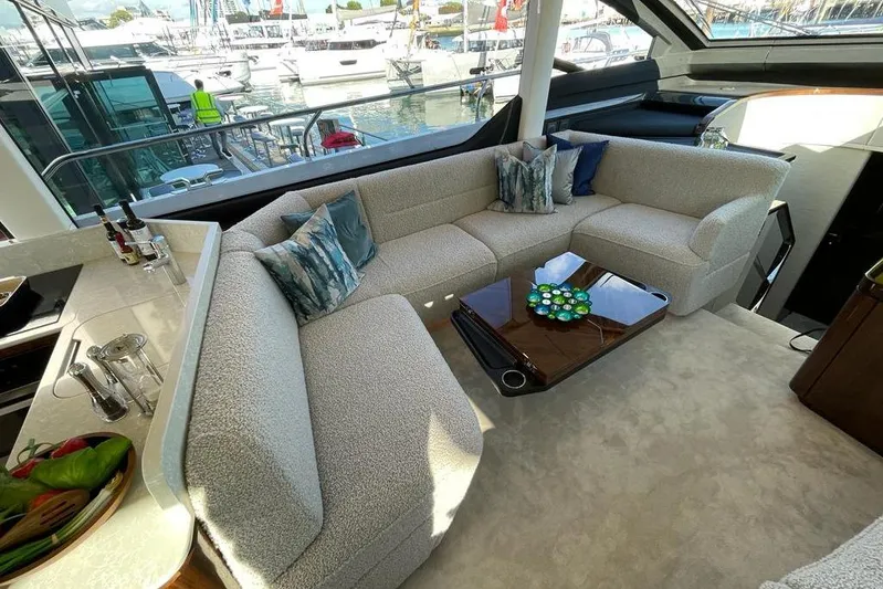 In Stock Yacht Photos Pics Luxurious interior of 2024 Fairline Squadron 58 yacht with plush seating and elegant decor.