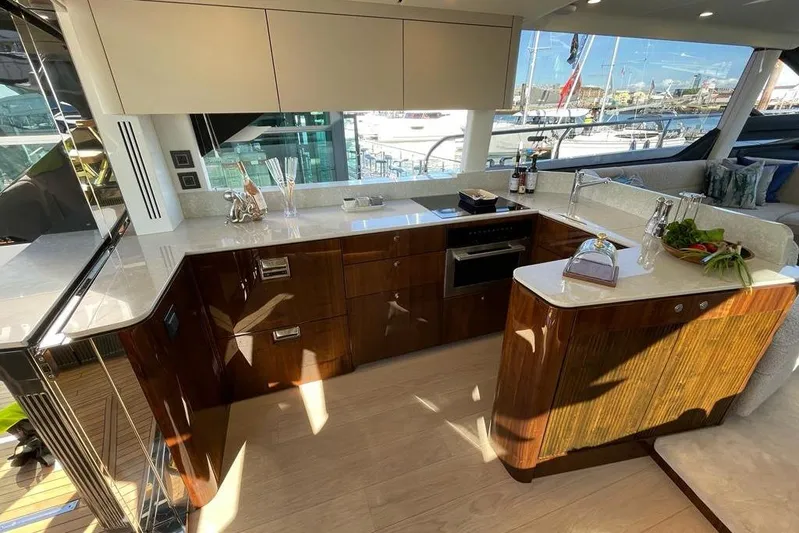 In Stock Yacht Photos Pics Luxurious kitchen interior of 2024 Fairline Squadron 58 yacht with modern amenities.
