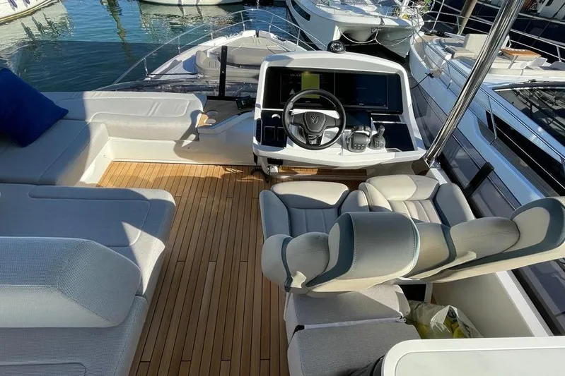 In Stock Yacht Photos Pics Luxurious 2024 Fairline Squadron 58 yacht cockpit with plush seating and modern controls.