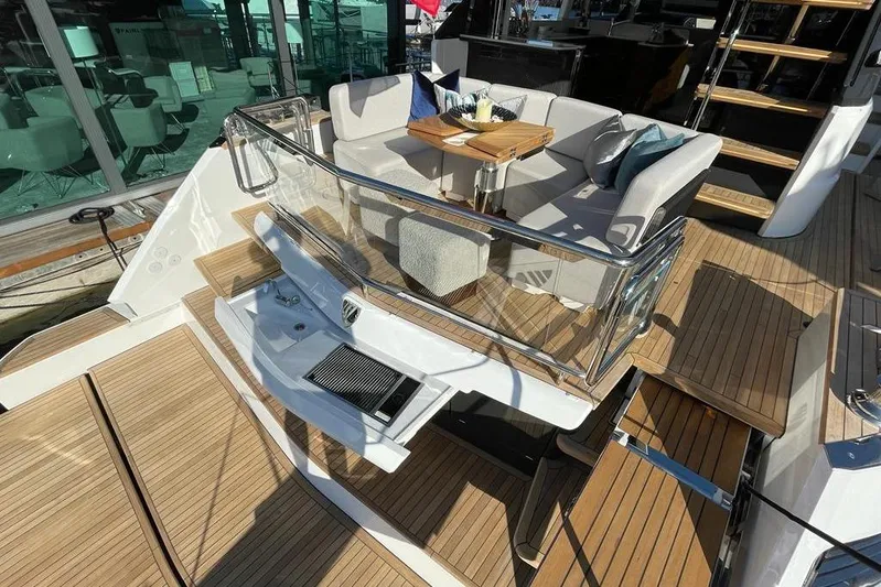 In Stock Yacht Photos Pics Luxurious 2024 Fairline Squadron 58 yacht deck with elegant seating and wooden flooring.