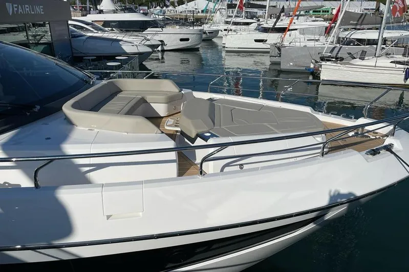 In Stock Yacht Photos Pics 2024 Fairline Squadron 58 yacht with sleek design and spacious deck at marina.