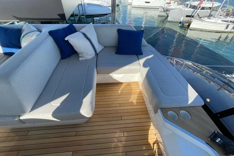 In Stock Yacht Photos Pics Luxurious seating area on 2024 Fairline Squadron 58 yacht with blue cushions.