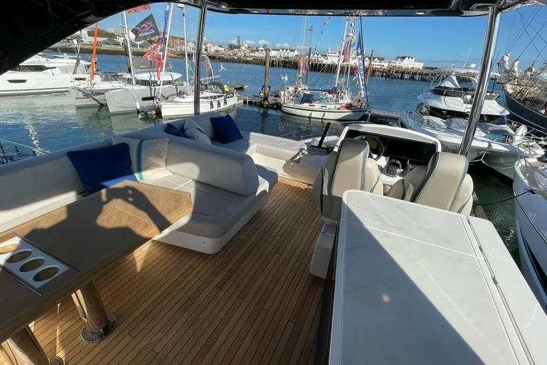 In Stock Yacht Photos Pics Luxurious 2024 Fairline Squadron 58 yacht interior with elegant seating and marina view.