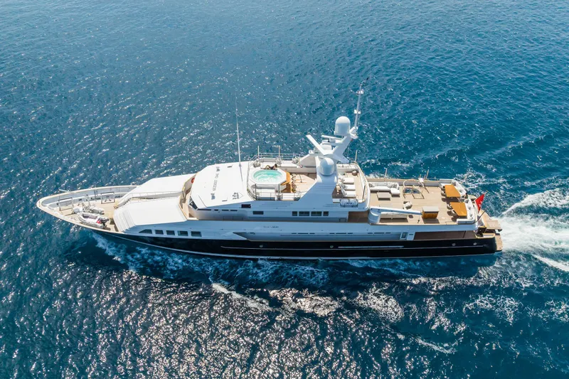 Emerald Yacht Photos Pics Luxurious 1990 Feadship yacht cruising on open blue sea.