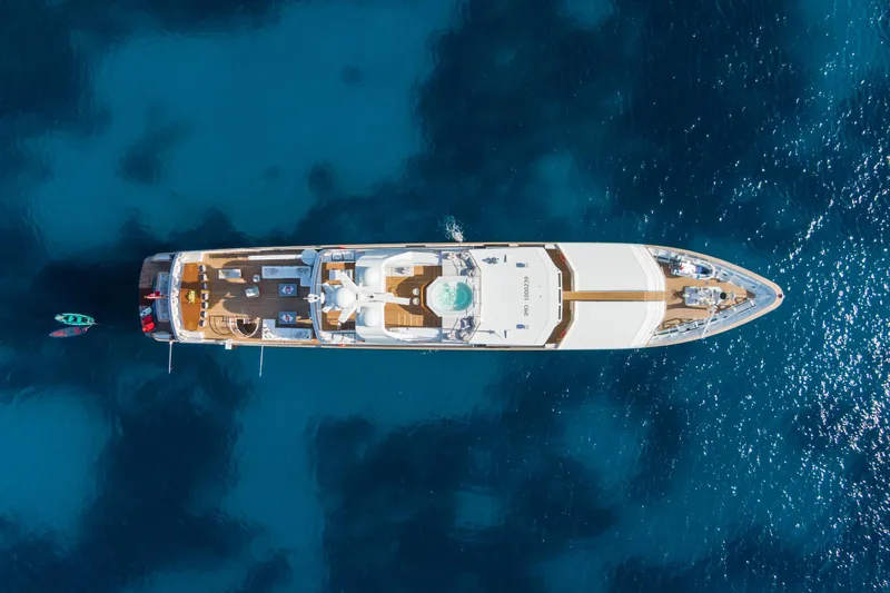 Emerald Yacht Photos Pics Aerial view of 1990 Feadship yacht on deep blue water.