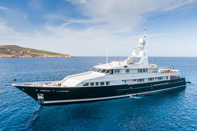Emerald Yacht Photos Pics Luxurious 1990 Feadship yacht cruising in clear blue waters.