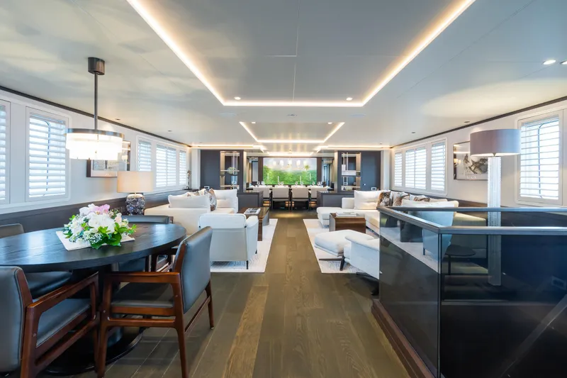 Emerald Yacht Photos Pics Luxurious interior of 1990 Feadship yacht with elegant seating and modern lighting.