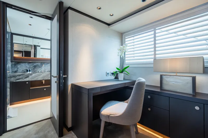 Emerald Yacht Photos Pics Luxurious Feadship yacht interior with desk, chair, and modern decor, built in 1990.