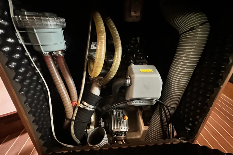  Yacht Photos Pics Engine compartment of 2007 Jeanneau Sun Odyssey 42 DS sailboat, featuring hoses and mechanical components.