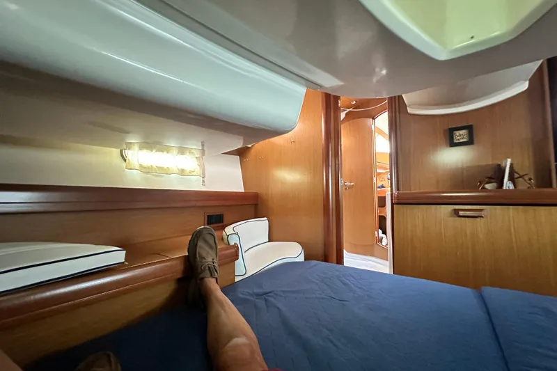  Yacht Photos Pics Interior view of 2007 Jeanneau Sun Odyssey 42 DS yacht cabin, featuring cozy wooden furnishings.