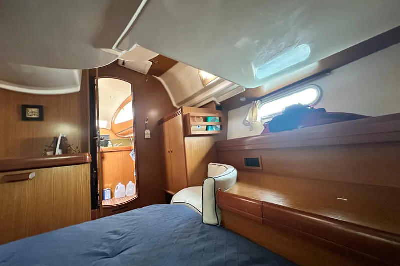  Yacht Photos Pics Interior cabin of 2007 Jeanneau Sun Odyssey 42 DS sailboat, featuring wood finish and cozy design.
