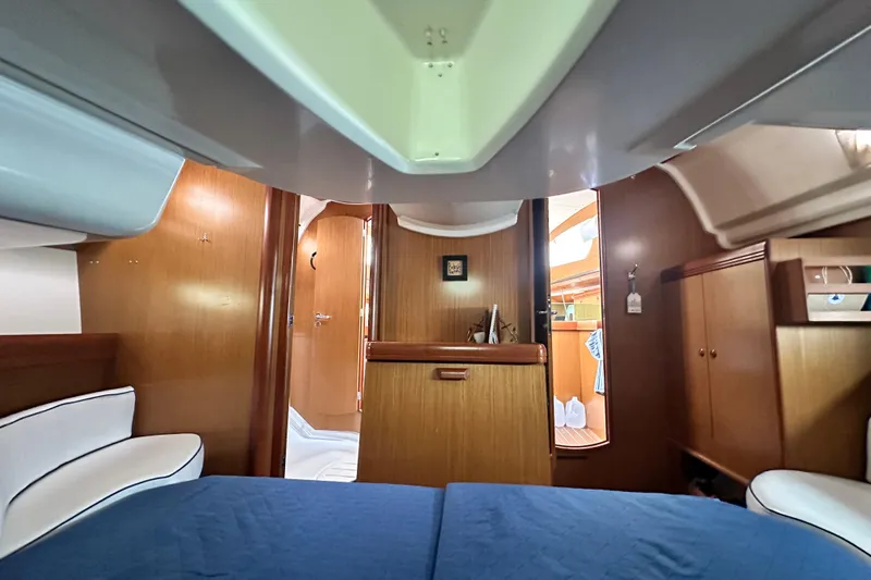  Yacht Photos Pics Interior of 2007 Jeanneau Sun Odyssey 42 DS yacht, featuring wood paneling and cozy seating.