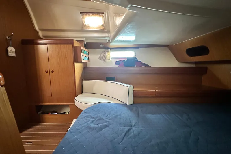 Yacht Photos Pics Interior cabin of 2007 Jeanneau Sun Odyssey 42 DS, featuring wood finish and cozy seating.