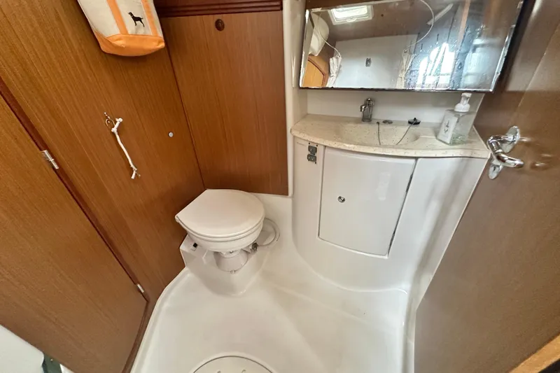  Yacht Photos Pics 2007 Jeanneau Sun Odyssey 42 DS yacht bathroom with toilet, sink, and mirror.