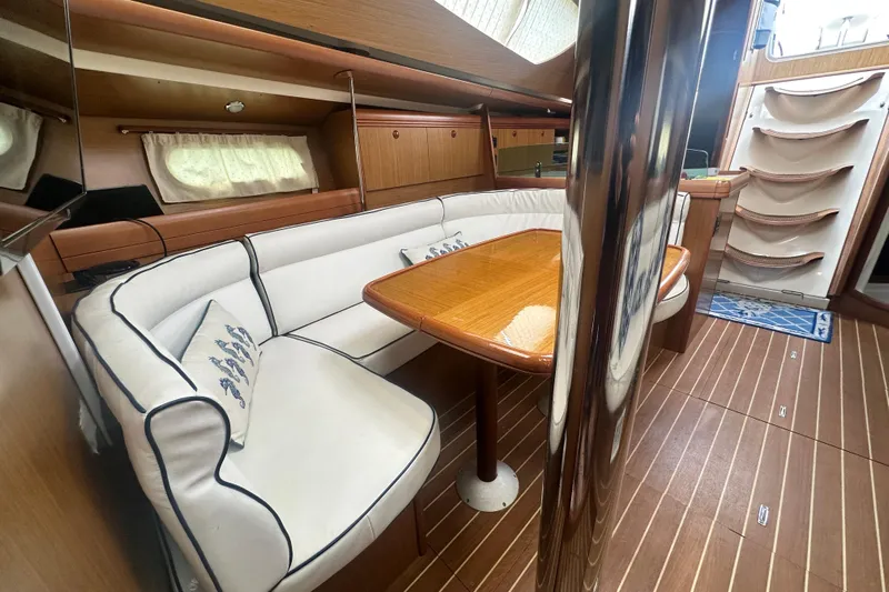  Yacht Photos Pics Interior of 2007 Jeanneau Sun Odyssey 42 DS yacht with elegant seating and wooden table.