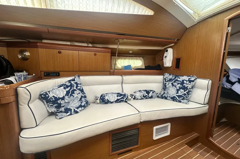 Yacht Photos Pics Interior of 2007 Jeanneau Sun Odyssey 42 DS with elegant seating and floral cushions.