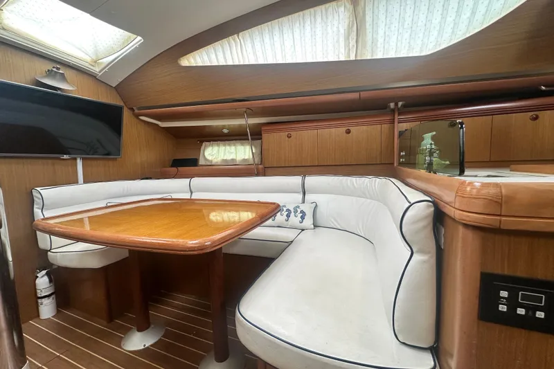  Yacht Photos Pics Interior of 2007 Jeanneau Sun Odyssey 42 DS yacht with elegant wood and white seating.