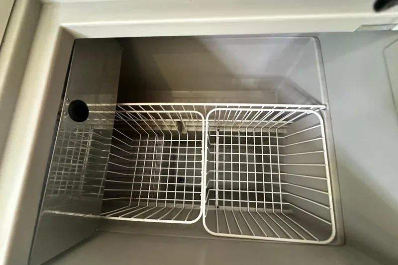  Yacht Photos Pics Interior view of Jeanneau Sun Odyssey 42 DS 2007 yacht refrigerator with wire baskets.