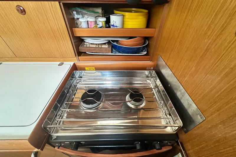  Yacht Photos Pics Compact kitchen area in a 2007 Jeanneau Sun Odyssey 42 DS sailboat.