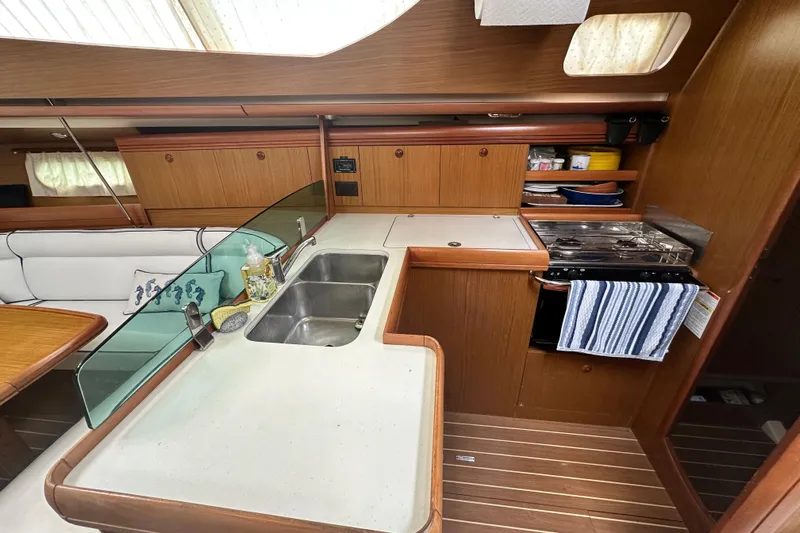  Yacht Photos Pics Interior of 2007 Jeanneau Sun Odyssey 42 DS yacht kitchen with sink and stove.