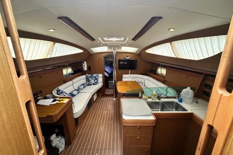  Yacht Photos Pics Interior of 2007 Jeanneau Sun Odyssey 42 DS yacht with elegant seating and kitchen area.