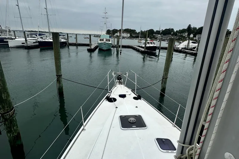  Yacht Photos Pics Jeanneau Sun Odyssey 42 DS 2007 docked in a serene marina setting.