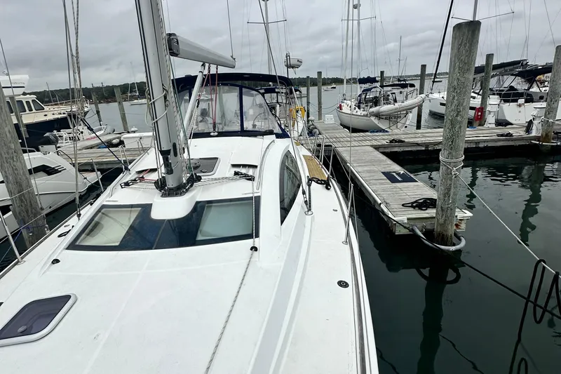  Yacht Photos Pics 2007 Jeanneau Sun Odyssey 42 DS sailboat docked at marina on a cloudy day.