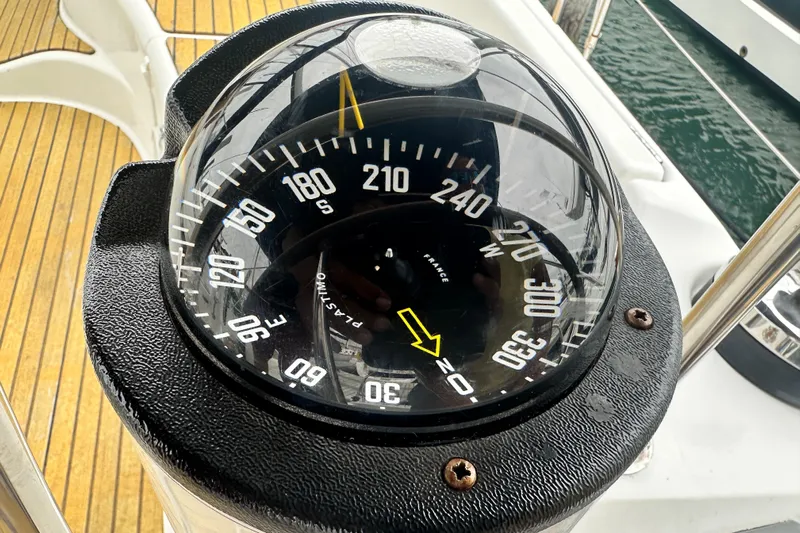  Yacht Photos Pics Compass on Jeanneau Sun Odyssey 42 DS yacht, 2007 model, with wooden deck background.