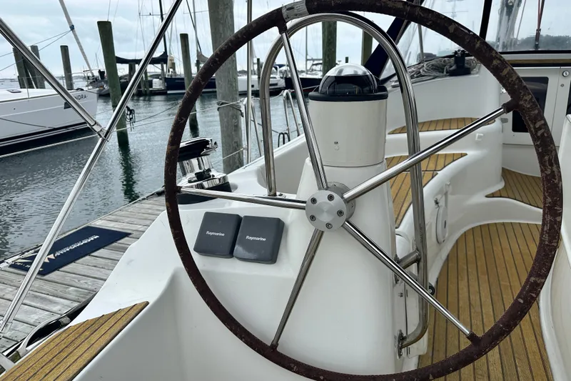  Yacht Photos Pics Steering wheel of 2007 Jeanneau Sun Odyssey 42 DS sailboat at marina dock.