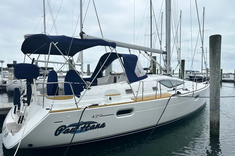  Yacht Photos Pics 2007 Jeanneau Sun Odyssey 42 DS sailboat docked at marina, featuring sleek design and blue canopy.