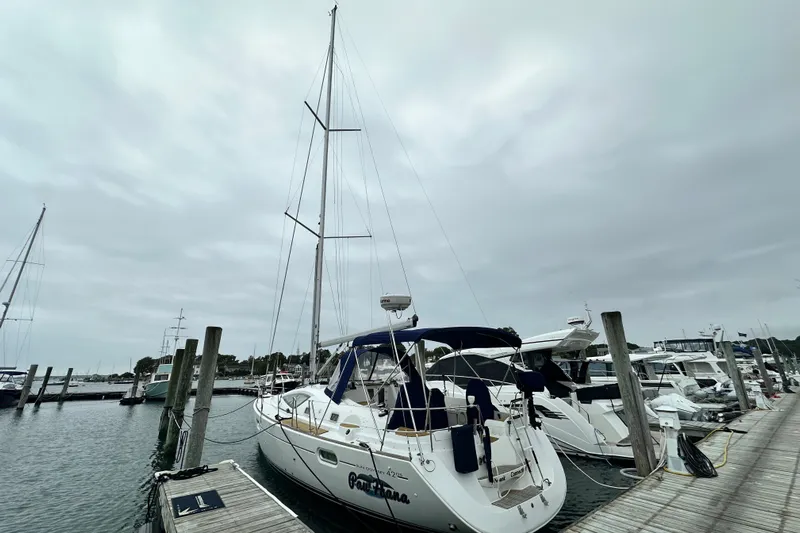  Yacht Photos Pics 2007 Jeanneau Sun Odyssey 42 DS sailboat docked at a marina under cloudy skies.