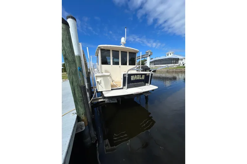 Eagle Yacht Photos Pics 2008 Mainship Pilot 34 docked at marina under clear blue sky.