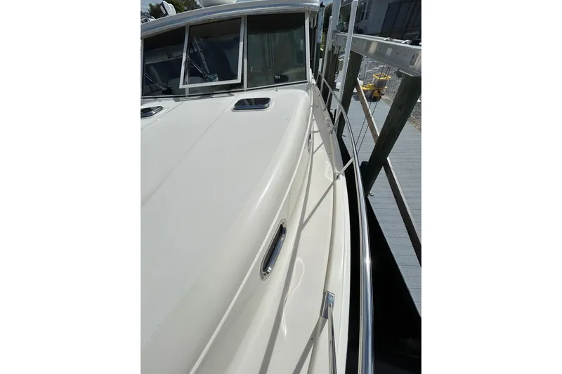 Eagle Yacht Photos Pics 2008 Mainship Pilot 34 boat deck with railing and windows, docked at marina.
