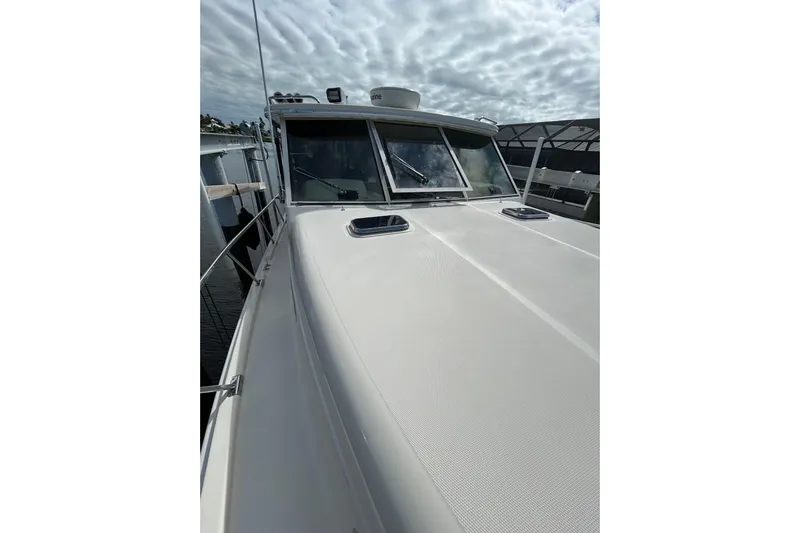 Eagle Yacht Photos Pics 2008 Mainship Pilot 34 boat deck with cloudy sky background.