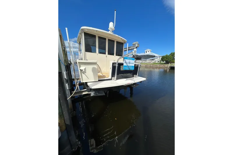Eagle Yacht Photos Pics 2008 Mainship Pilot 34 docked at marina under clear blue sky.