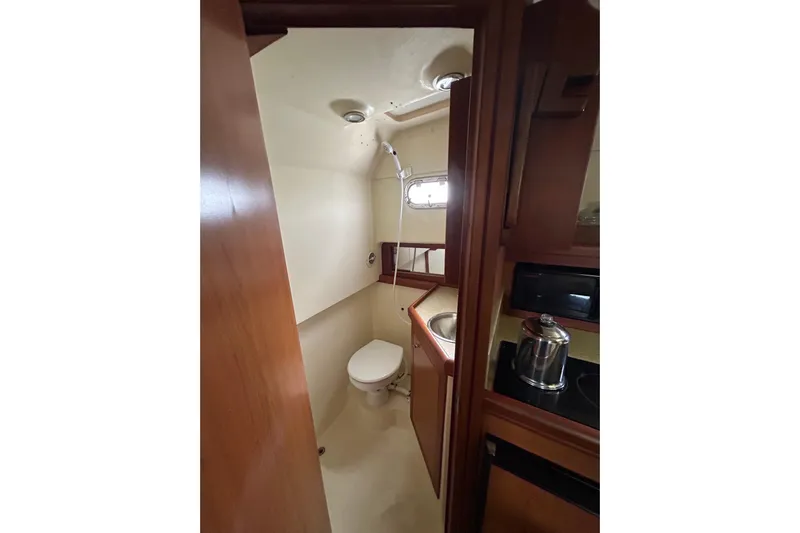 Eagle Yacht Photos Pics 2008 Mainship Pilot 34 boat interior with compact bathroom and kitchenette.