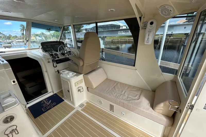Eagle Yacht Photos Pics 2008 Mainship Pilot 34 interior with helm, seating, and waterway view.