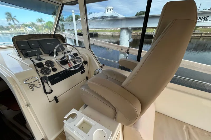 Eagle Yacht Photos Pics 2008 Mainship Pilot 34 helm with steering wheel, navigation screens, and captain's chair.