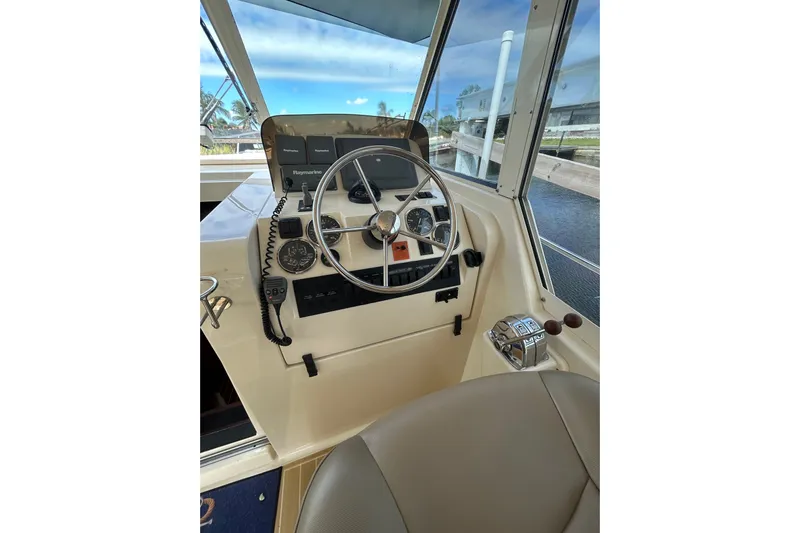 Eagle Yacht Photos Pics 2008 Mainship Pilot 34 helm with steering wheel and navigation controls.