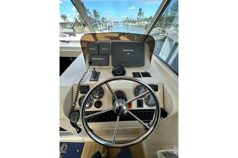 Eagle Yacht Photos Pics 2008 Mainship Pilot 34 helm with Raymarine navigation system and steering wheel.