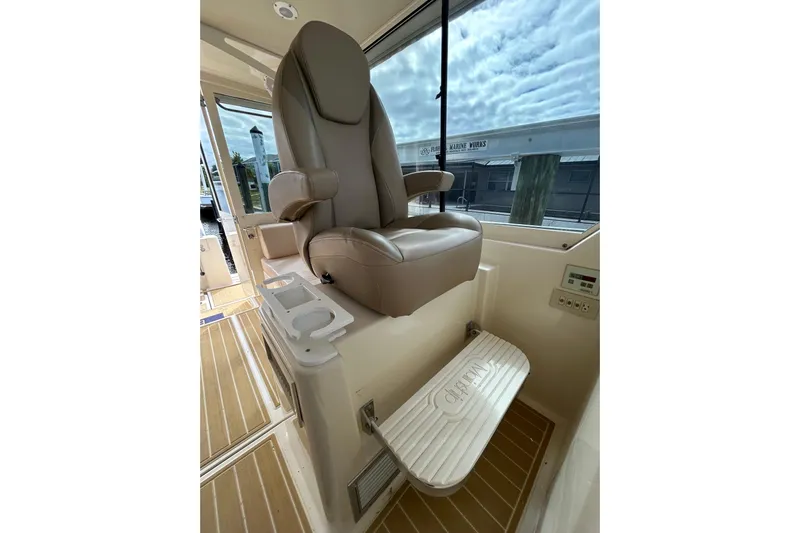 Eagle Yacht Photos Pics Captain's chair on 2008 Mainship Pilot 34 boat with footrest and cup holders.