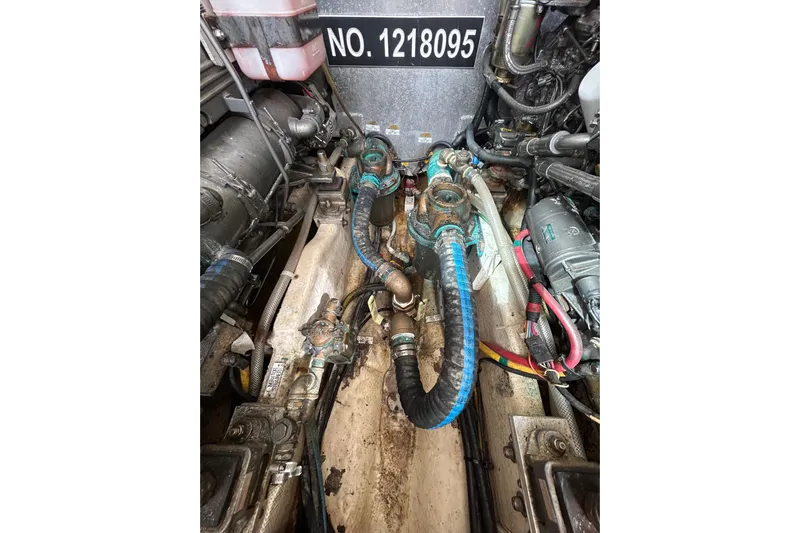 Eagle Yacht Photos Pics Engine room of a 2008 Mainship Pilot 34 boat, showing mechanical components and hoses.