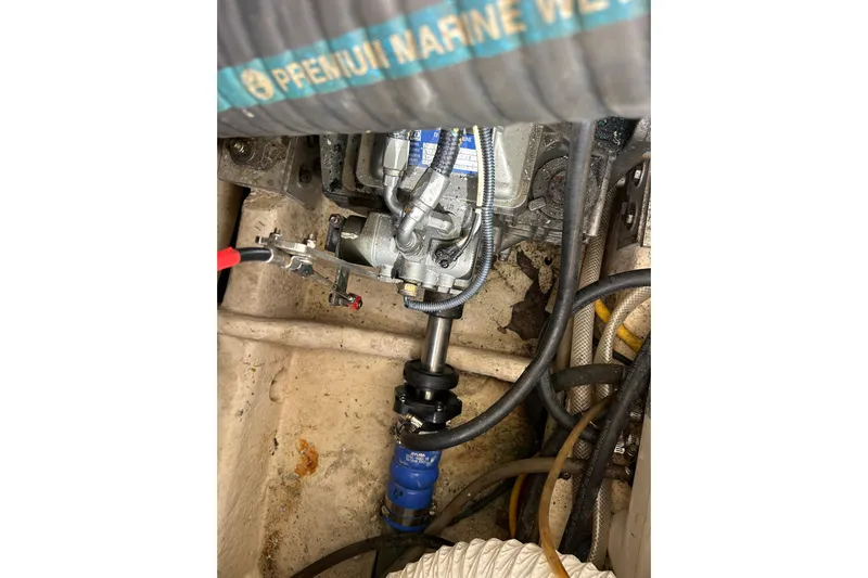 Eagle Yacht Photos Pics Engine compartment of 2008 Mainship Pilot 34 with visible hoses and mechanical components.